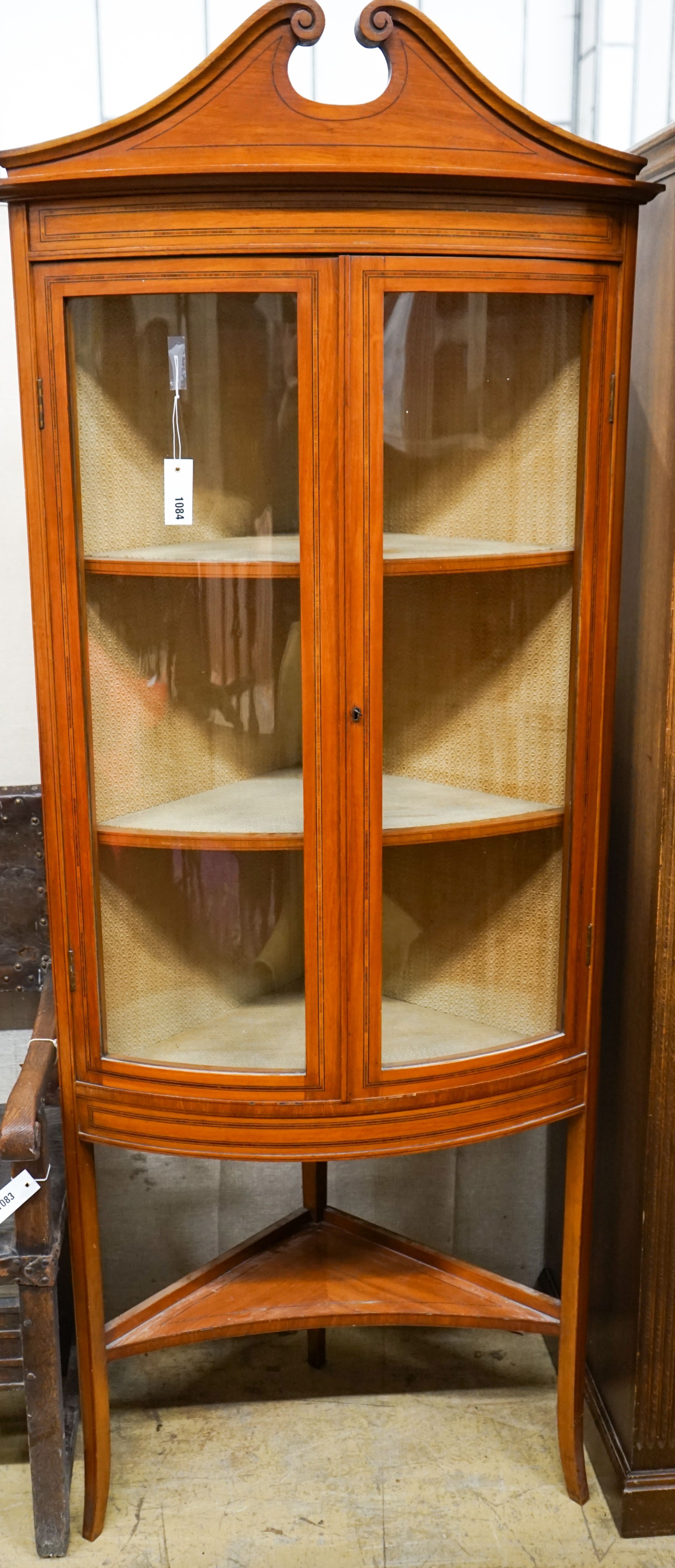 An Edwardian banded satinwood bowfront standing corner cabinet, width 76cm, depth 41cm, height 190cm